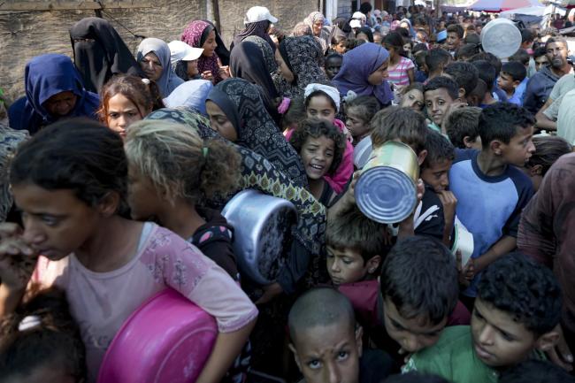 Palestinians line up for food distribution in Deir al-Balah, Gaza Strip, Thursday, Oct. 17, 2024.