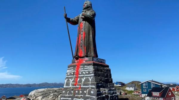 Nuuk's Hans Egede statue on 21 June with the word "decolonize" and red paint daubed on it