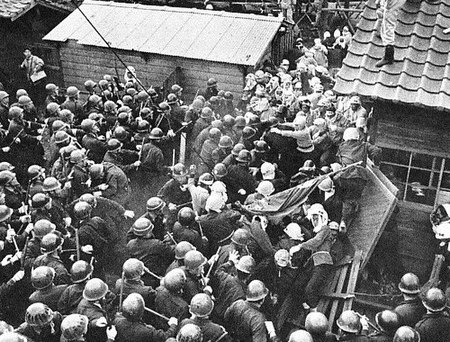 Police with helmets and batons clash with striking coal miners at the Miike mine, May 12, 1960